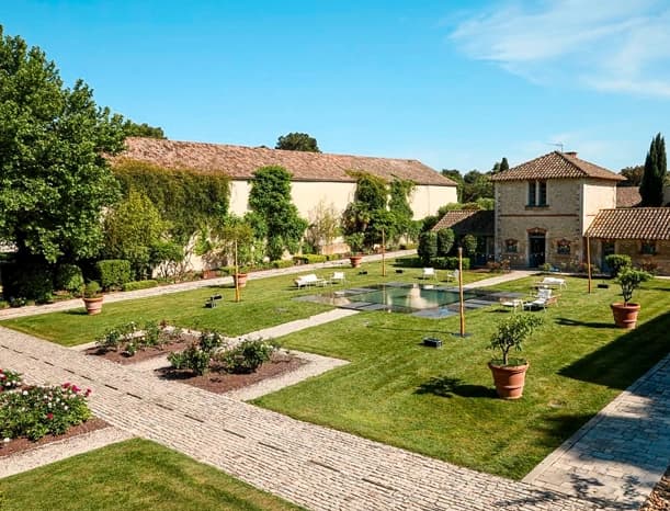 Estate courtyard with a basin, paved paths and rose beds